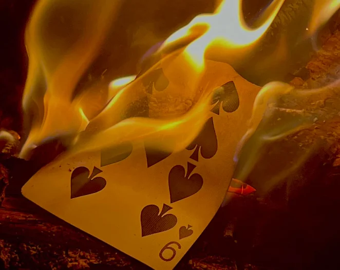 a playing card on fire